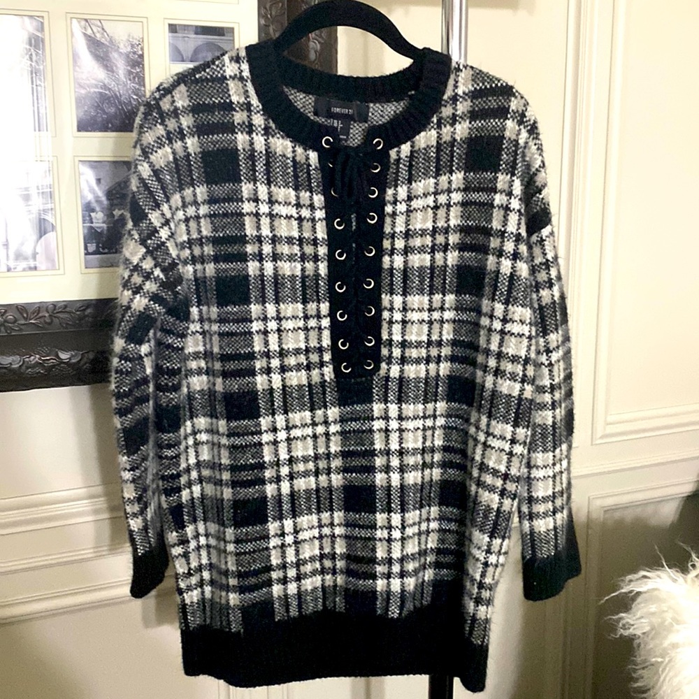 A soft black, white and beige plaid sweater